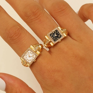 Macro view of adjustable watch-style gold rings with crystal inlay and dual dials