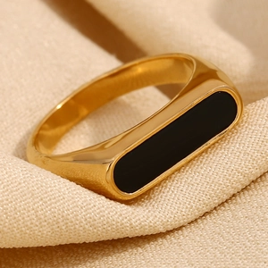 Minimalist 18K gold plated stainless steel ring with black rectangular inlay on beige fabric
