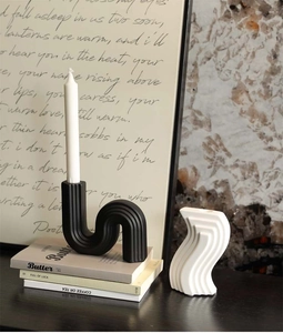 Detail showing the vertical ribbed texture on modern wavy ceramic candle holders in matte finish