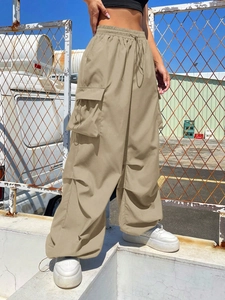 Detailed view of khaki cargo pants featuring large functional pockets and drawstring waist