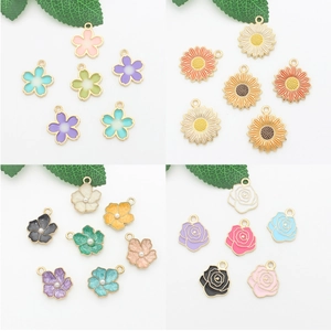 Detail of floral enamel charms including cherry blossoms and roses for DIY jewelry making