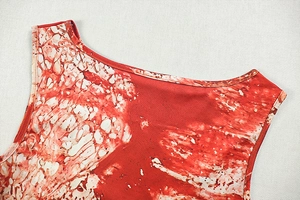 Detail of round neckline and red marble print on sleeveless A-line mini dress