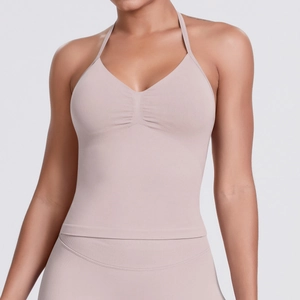Detailed close-up of the gathered V-neckline on this nude pink halter sports yoga bra