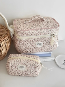 Detailed view of floral quilted corduroy makeup bag set with zipper and fabric label