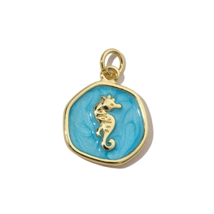 Detailed view of blue enamel seahorse charm pendant with golden metallic borders