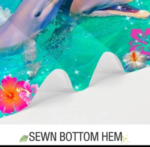 Detail showing the sewn bottom hem of the ocean dolphin shower curtain for durability