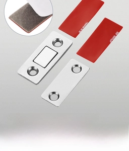 Macro detail of magnetic door catch set with 3M adhesive and brushed steel finish