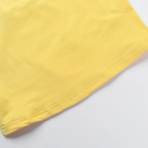 Detailed close-up of yellow knit fabric texture and high-quality hem stitching