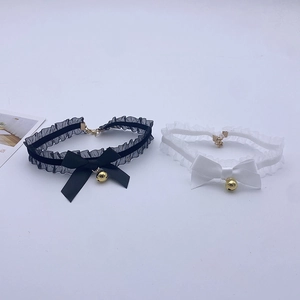 Detailed view of lace chokers with satin bows and small golden bells for cosplay