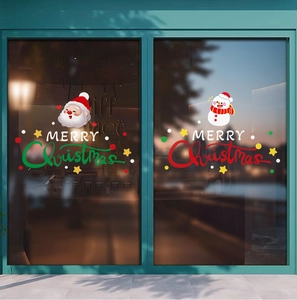 Detailed view of Santa and snowman electrostatic window decals for Christmas store display