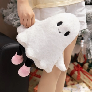 Close-up of a plush white ghost doll with pink boots and hand-held holiday decor