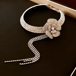 Elegant silver necklace with diamond-encrusted flower pendant and luxury tassels