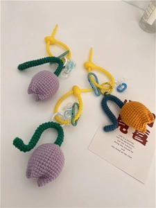 Detail of handmade crochet tulip keychain with wavy strap and acrylic chain decoration
