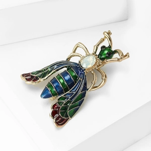 Golden bumblebee brooch with colorful enamel and opal-like gemstone on white background