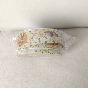 Detail of vintage floral Easter tin box with handle in protective plastic film wrap