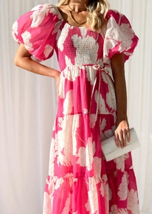 Close-up of pink floral dress featuring elegant puff sleeves and textured layering