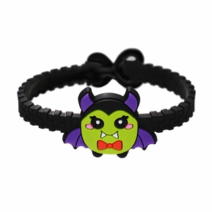 Detail of black textured PVC bracelet featuring a cute green and purple cartoon bat charm