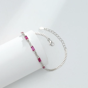 Macro detail of S925 sterling silver bracelet featuring magenta cubic zirconia stones