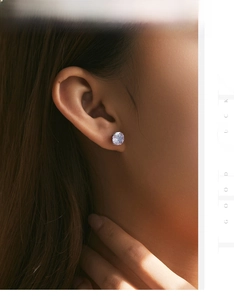 Macro shot of s925 silver stud earring with rose-cut lavender purple crystal on ear