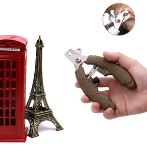 Close-up of pet nail clippers with stainless steel blade, safety guard, and locking mechanism