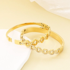 Luxury gold stainless steel interlocking pavé bangles set for women on display