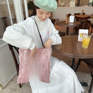 Detailed close-up of pink velvet tote bag with vintage rose floral patch and ribbed texture