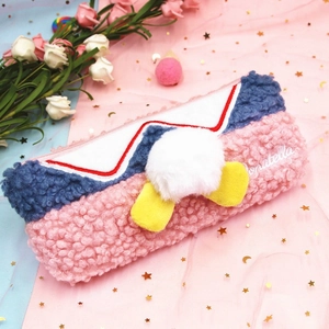 Cute plush pencil case with white fuzzy tail and yellow webbed feet in a pink aesthetic setting