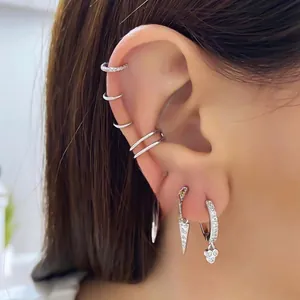 Macro shot of S925 silver geometric triangle earrings with cubic zirconia ear stacking set