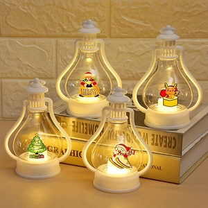Close-up of four white vintage LED Christmas lanterns with festive Santa and deer patterns