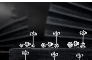 Detailed view of silver titanium steel earrings with 6-prong set cubic zirconia stones