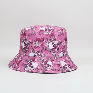 Close-up of fabric bucket hat featuring pink floral and skull digital print patterns