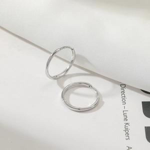 Close-up of S925 sterling silver hoop earrings with clear hallmark engraving on inner surface