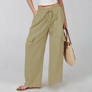 Detailed view of high waist drawstring and large cargo pockets on wide leg trousers