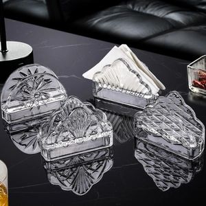 Minimalist crystal glass napkin holders in various patterns on black marble surface
