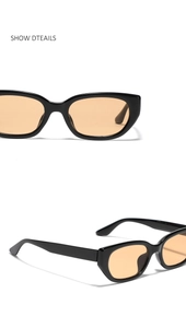 Detail view of narrow rectangular sunglasses with black frame and light amber lenses