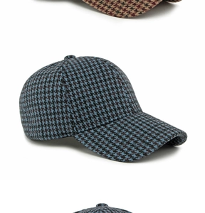 Close-up of the vintage blue and black houndstooth pattern on a wool baseball cap