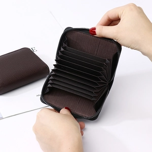 Detailed interior of a brown leather accordion card holder with multiple slots