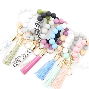 Silicone bead wristlet keychains with leather tassels and natural wood beads assortment
