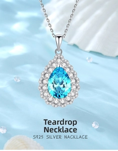 Macro detail of S925 silver pear-cut blue gemstone pendant necklace on water background