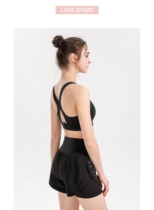 Detail of high-waist double-layer yoga shorts with breathable mesh and side lettering