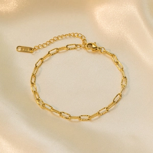 18k gold plated stainless steel floral embossed bracelet with lobster clasp and silk backdrop