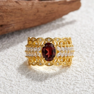 Macro shot of vintage silver ring with oval garnet gemstone and hollow floral patterns