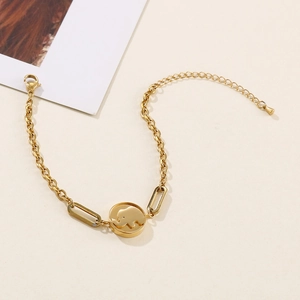 Elegant gold elephant pendant bracelet with adjustable geometric chain links on beige background