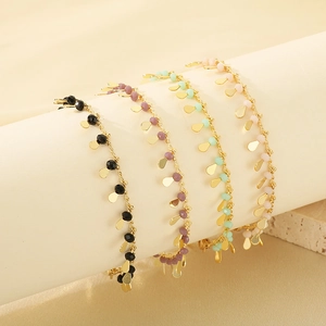 Elegant gold chain bracelet set with colorful beads and shiny teardrop metal pendants