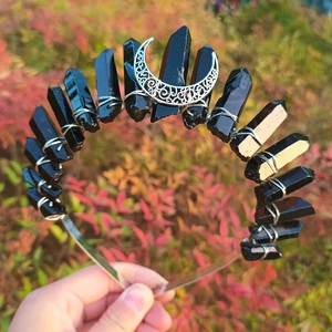 Detail of handmade crown with raw black crystals and hollow silver crescent moon charm