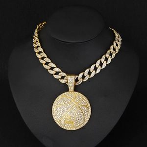 Detailed close-up of golden iced-out basketball pendant necklace with I'm Back engraving