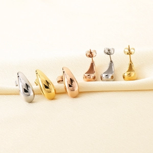 Detailed view of hollow teardrop earrings in gold, silver, and rose gold polished finishes