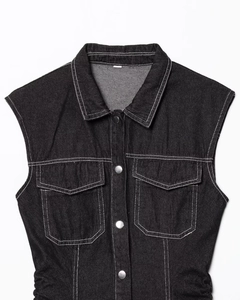 Detail of dark charcoal denim dress with contrast white stitching and metal buttons