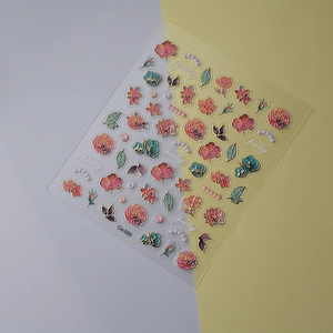 Detail of floral nail stickers with gold outlines, pink flowers and pretty text