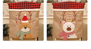 Detail of Christmas chair covers featuring elk and bear patterns on burlap fabric